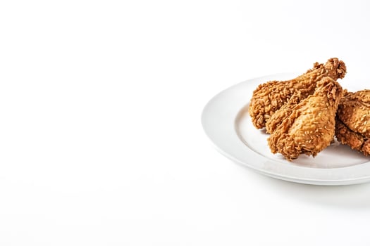 Crispy Fried Chicken Drumsticks on White Plate photo