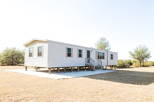 White Mobile Home on a Grassy Field photo