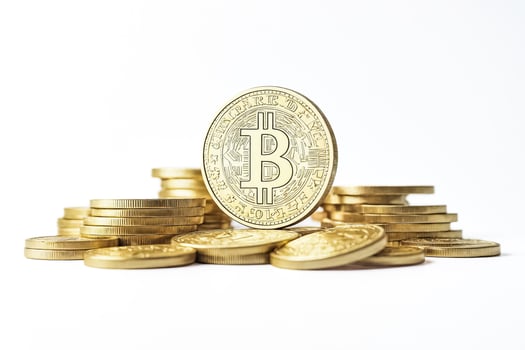 Bitcoin Cryptocurrency Gold Coins on White Background photo