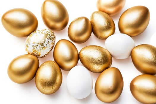 Golden Eggs and White Eggs on White Background photo