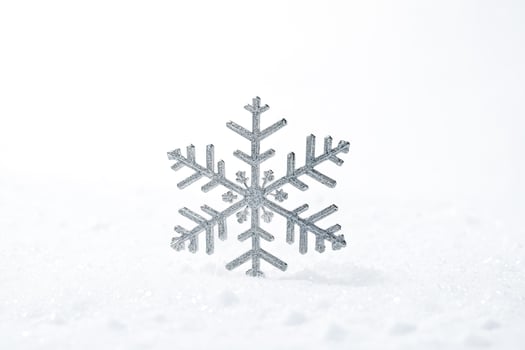 Silver Snowflake on White Snow photo