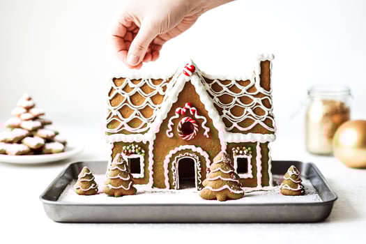 Decorated gingerbread house with icing and candy canes photo