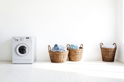 White Laundry Room with Wicker Baskets and a Washing Machine photo