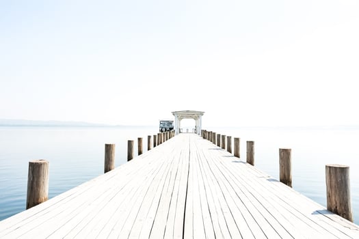Wooden Pier Leading to a Gazebo on a Calm Lake photo