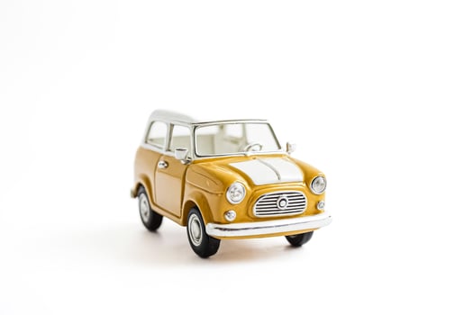 Yellow Vintage Toy Car on White Background photo