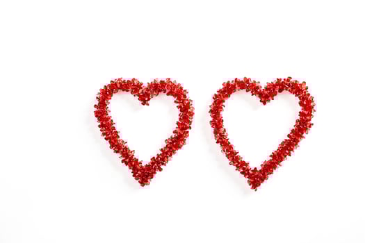 Two Red Hearts Made of Flowers on White Background photo