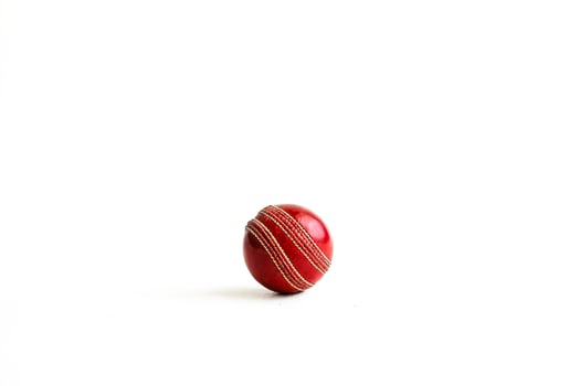 Red cricket ball isolated on white background photo