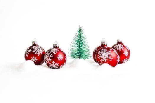 Red Christmas Baubles and a Tiny Christmas Tree in Snow photo