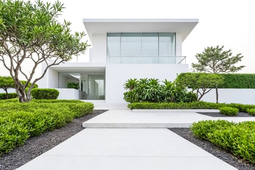 Modern White House with Lush Green Landscape photo