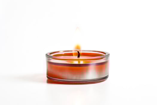 Burning Orange Candle in a Glass Jar photo