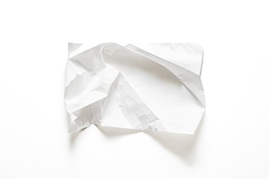 Crumpled white paper on white background photo