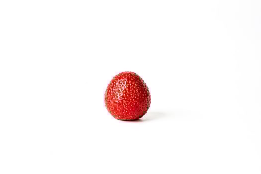 Single Red Strawberry on White Background photo