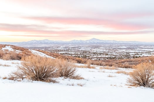 Snow-covered mountain range at sunset photo