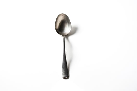 Single Silver Spoon on White Background photo