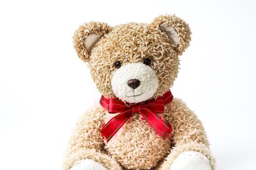 Closeup of a Cute Teddy Bear with a Red Bow photo