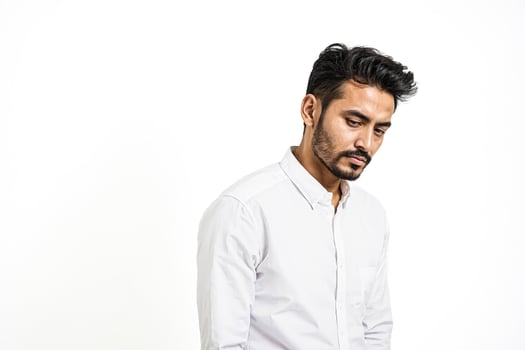 Thoughtful Man in White Shirt Against White Background photo