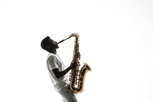 Silhouette of a Saxophonist Playing on White Background photo