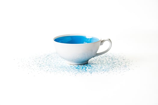 Blue Teacup with Spilled Blue Liquid photo
