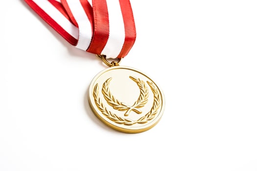 Gold medal with red and white ribbon isolated on white background photo