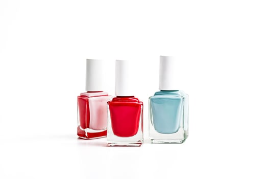 Three Nail Polish Bottles in Pink, Red, and Blue photo
