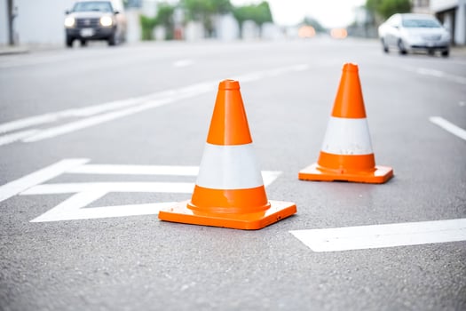 Orange traffic cones on an asphalt road photo