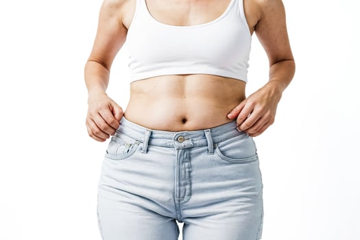 Woman holding her stomach with her hands photo