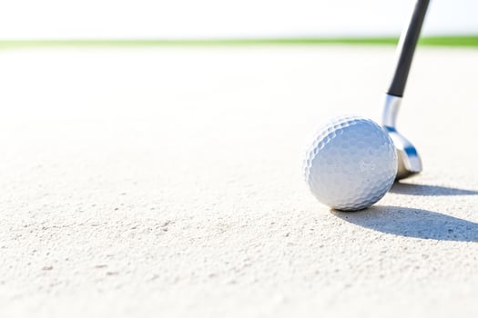 Golf Ball on Green Grass with Club photo