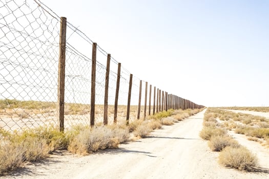 A long fence line in the desert photo