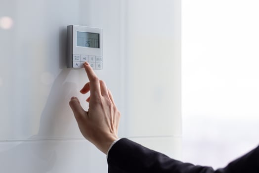 The air conditioning and heating control panel for the apartment and office is located on a white wall. photo