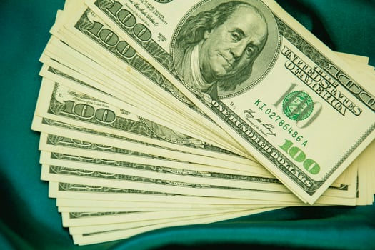 Lots of dollars on a beautiful background in a photo studio