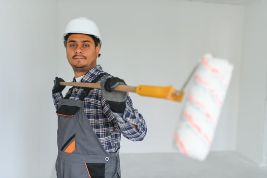 Indian worker makes repairs in an apartment photo