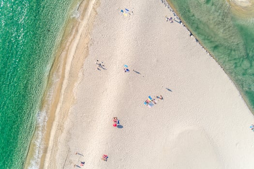 people enjoying the beach in summer, aerial top view with a drone. photo