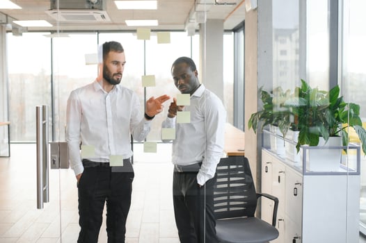 Young businessman manager writing strategy ideas on sticky notes. Business project planning. photo