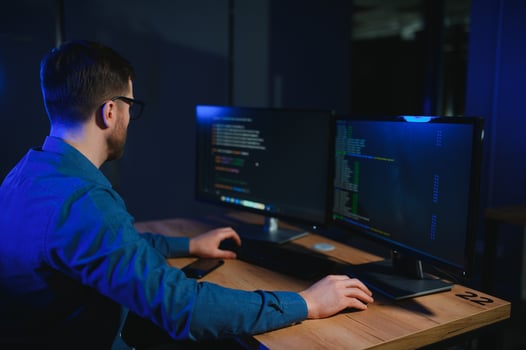 Smart Male IT Programer Working on Desktop photo