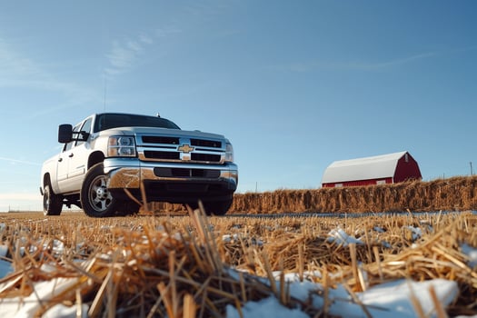 Strength Pickup truck parked on farm with haystacks and barn in the background under clear blue sky photo