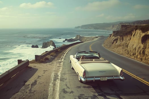 Classic Convertible Cruising Coastal Road with Ocean Waves Background in Nature photo