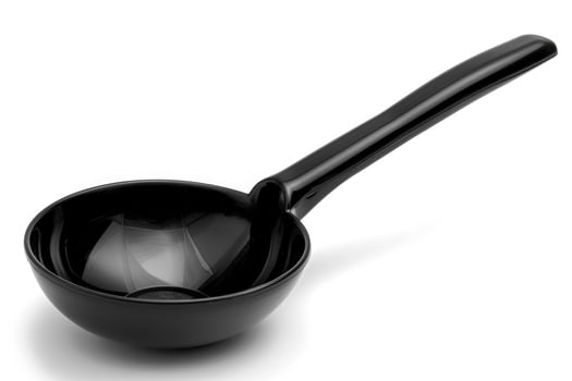 Black plastic soup ladle on a white background. photo