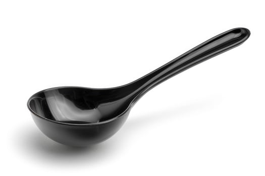 Black plastic soup ladle on a white background. photo