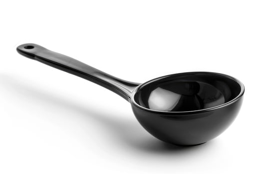 Black plastic soup ladle on a white background. photo