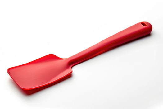 Red silicone spatula on a white background. photo