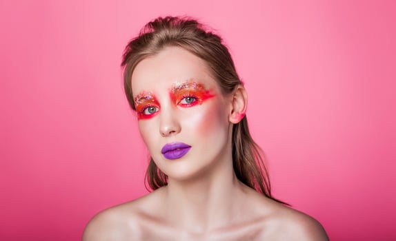 Woman with Bold Makeup on Pink Background photo
