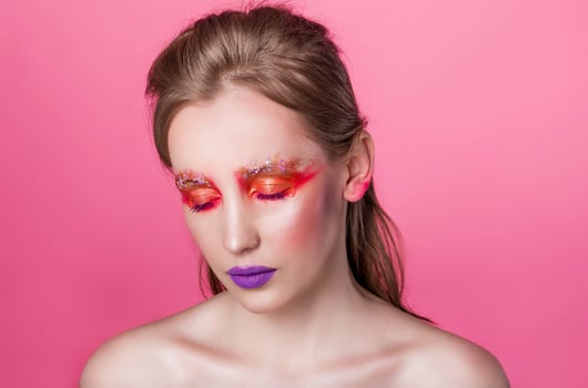 Serene Woman with Eyes Closed and Colorful Makeup photo