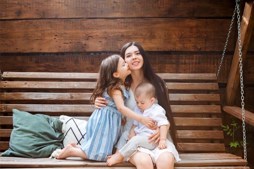 Smiling woman with cute kids on terrace photo