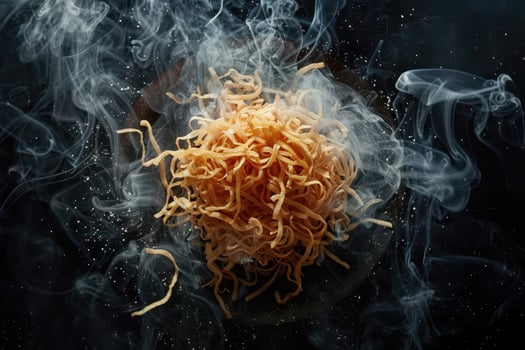 Steaming Golden Noodles on a Black Background photo
