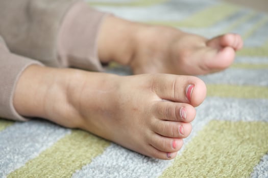 Bare feet of a child on a wooden floor represent innocence and playful moments at home photo