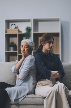 Sad teen granddaughter hugging depressed mature grandmother, giving support, help, comforting, consoling granny. Teenage daughter girl and middle aged mother going through family problems photo