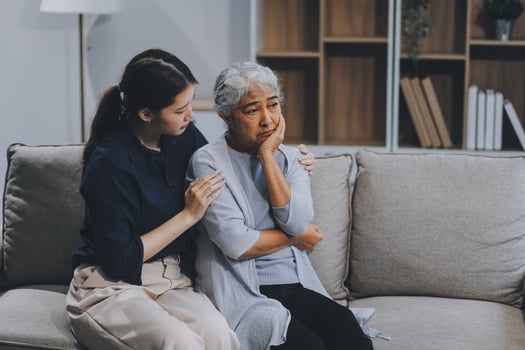 Sad teen granddaughter hugging depressed mature grandmother, giving support, help, comforting, consoling granny. Teenage daughter girl and middle aged mother going through family problems photo