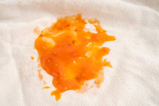 Dirty tomato sauce stain or ketchup on cloth to wash with washing powder, cleaning housework concept. photo
