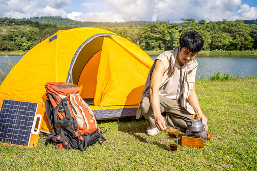 Young asian man relax travel nature in the holiday, camping and boiling water for dripping coffee, he camping on holiday. photo
