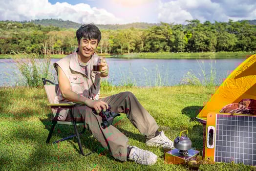 Young asian man relax travel nature in the holiday, camping and drinking coffee after boiling water, he camping on holiday. photo